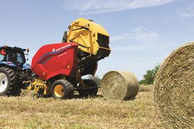 The New Holland Pro-Belt Round baler finishing up a bale of hay in the field.