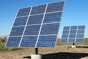 Two groups of 3 X 4 solar panels together as 12 on a post in a rural area