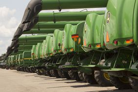 Line of John Deere combines at auction sale