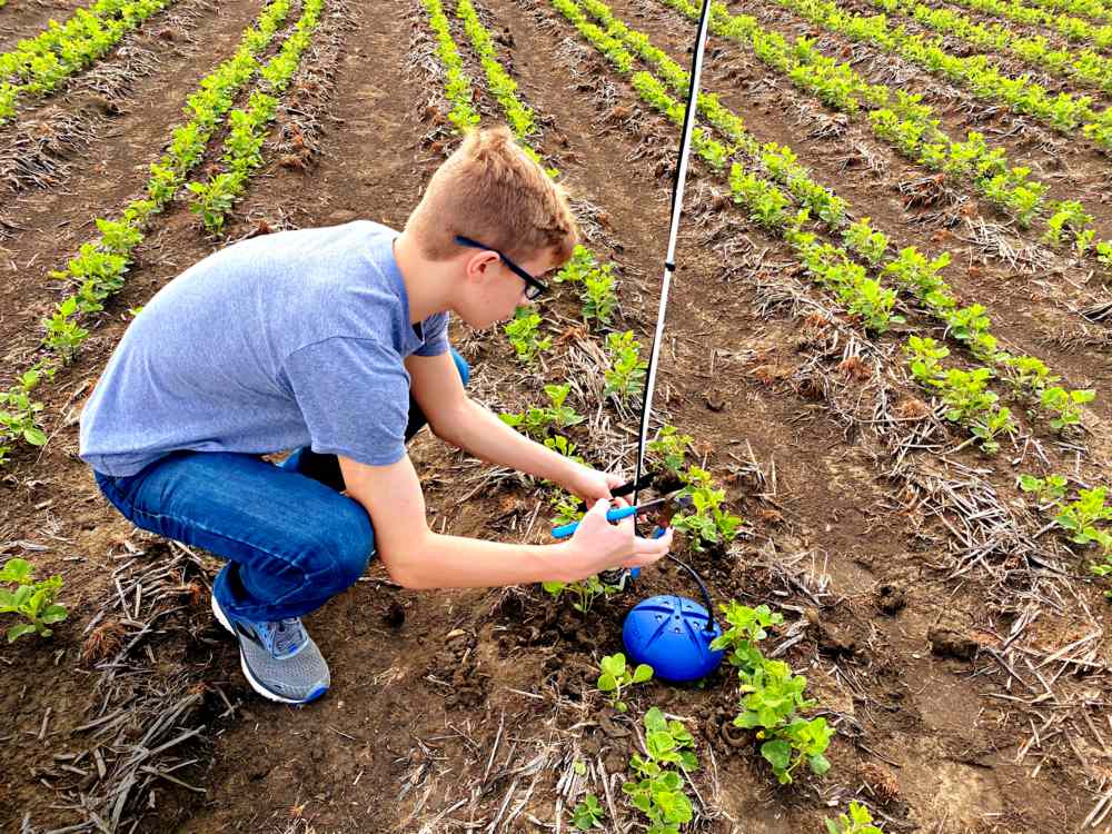 Trace Senter installing a soil moisture monitor