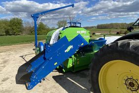 The new T7170 Ag Bagger by RCI attached to the hitch of a tractor.