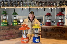 A man stands with colorful lanterns