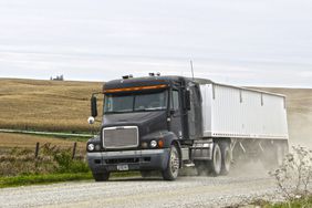 A semi on a gravel road.