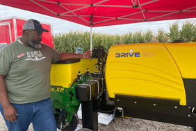 Man standing next to 3RIVE 3D system.