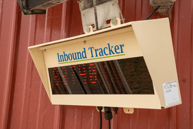 A mechanical tracker from Topcon displays the weight of a feed truck