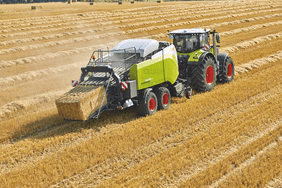 The Claas Quadrant Evolution square hay baler in the field.